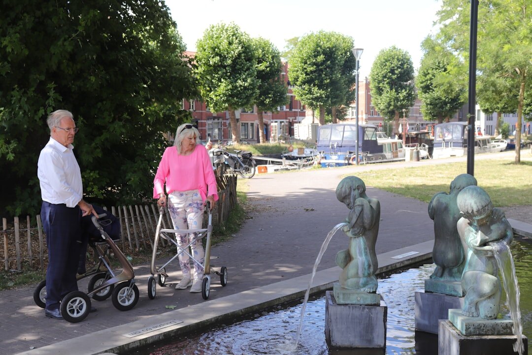 elderly couple walking in park